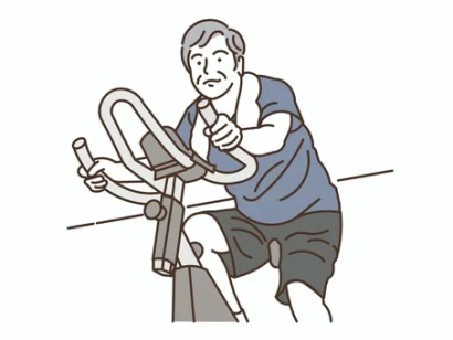 ジムでエアロバイクを漕ぐ笑顔のシニア男性